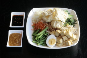 I4 Gado Gado White cabbage, bean sprouts, cucumber, string beans, water spinach, tofu, egg, fried onions, Emping Melindjo, spicy sweet soy sauce and peanut sauce.